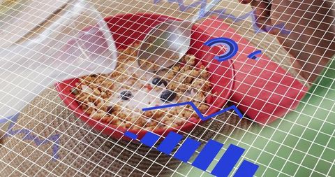 Peeking hamster resting in red bowl with cereal and grid overlay with blue data graphics