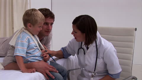 Doctor Examining Child with Concerned Parent in Hospital Setting