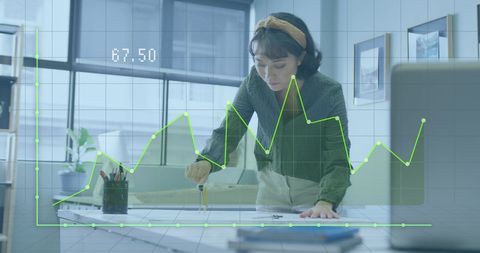 Businesswoman Analyzing Financial Graph in Modern Office - Download Free Stock Images Pikwizard.com