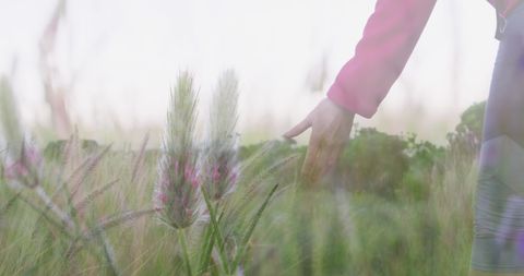 Senior Woman Enjoys Peaceful Hike in Scenic Grassland Sunset