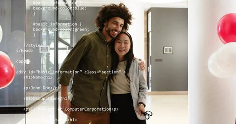 Smiling coworkers celebrating office ribbon-cutting in modern lobby with html code overlay