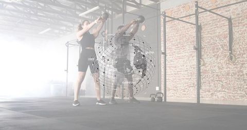 Partner kettlebell swing workout in industrial gym with holographic globe overlay