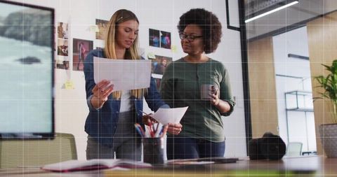 Creative Female Colleagues Collaborating in Modern Office Workspace