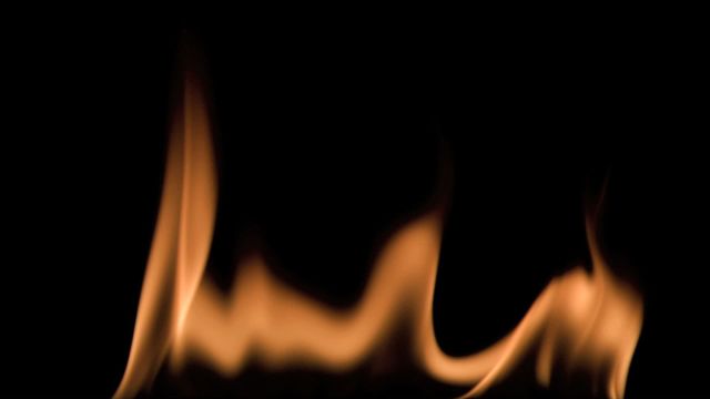 Glowing flames rise against a black background in striking slow motion, creating a sense of warmth, danger, and intensity. Ideal for use in graphics involving heat concepts, dramatic effects, energy, or to symbolize passion and strength.