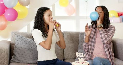 Friends Celebrating Birthday with Balloons in Living Room