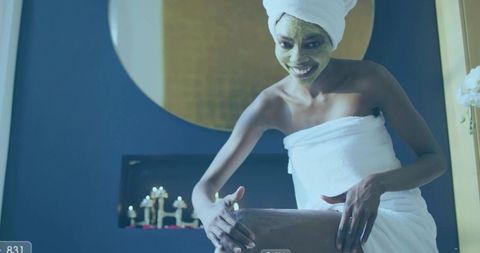 Woman Enjoying Self-Care Routine in Spa Bathroom