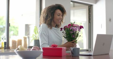 Happy Woman Receiving Gift and Flowers During Online Video Call - Download Free Stock Images Pikwizard.com