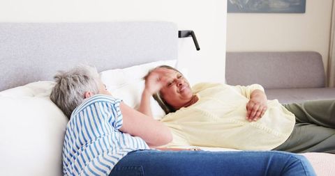 Joyful Senior Lesbian Couple Relaxing in Sunny Bedroom