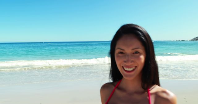 Happy young woman in bikini running on beach 4k