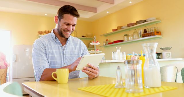 Smiling Man Using Digital Tablet in Modern Kitchen - Download Free Stock Images Pikwizard.com