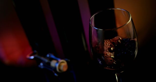 Close-up of red wine poured in wine glass. Wing corkscrew beside wine glass. 4k