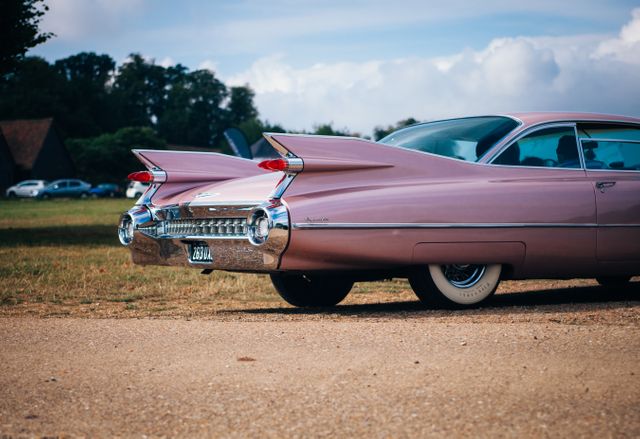 Vintage Pink Cadillac Parked Outdoors on Sunny Day - Download Free Stock Photos Pikwizard.com