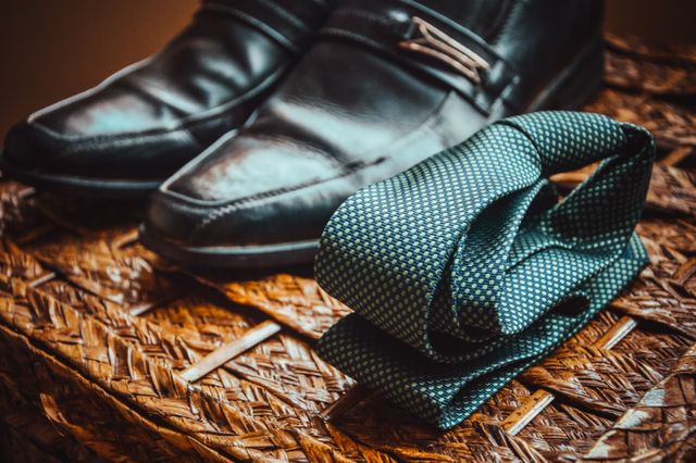 Formal Black Leather Shoes and Green Tie on Woven Surface - Download Free Stock Photos Pikwizard.com