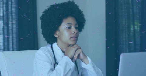 Focused female doctor analyzing data on laptop in medical office