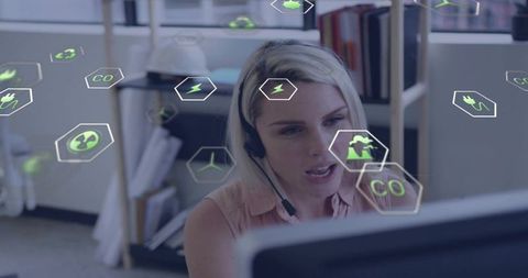 Call center agent wearing headset speaking while interacting with renewable energy icons