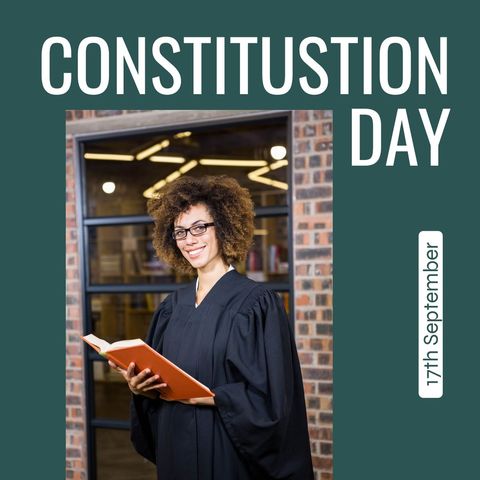 Smiling Attorney Holding Book Celebrates Constitution Day
