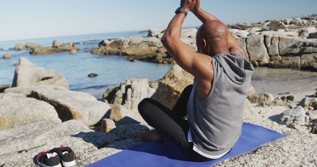 Man Practicing Yoga on Beach Rocks by Ocean - Download Free Stock Images Pikwizard.com