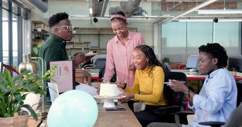 Colleagues enjoying cake for office celebration