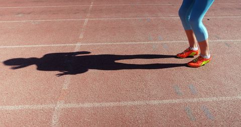 Female athlete jumping on track