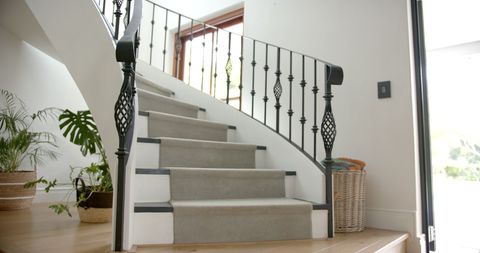 Elegant Carpeted Spiral Staircase in Sunlit Luxury Home Interior - Download Free Stock Images Pikwizard.com