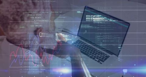 Mature professional reviewing code on laptop at desk