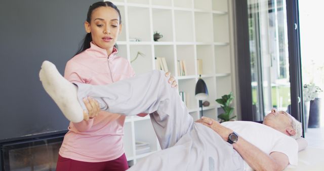 Female physiotherapist providing leg therapy to elderly man - Download Free Stock Images Pikwizard.com