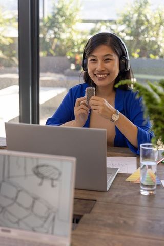 Korean designer showcasing fabric samples in modern home office