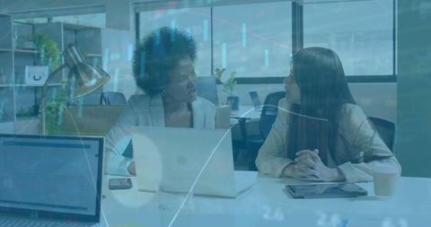 Businesswomen Collaborating on Financial Analysis in Modern Office - Download Free Stock Images Pikwizard.com