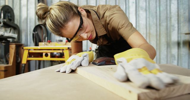 Young Female Carpenter Sanding Wood in Workshop - Download Free Stock Images Pikwizard.com