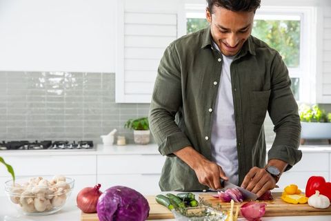 Man Preparing Fresh Meal in Contemporary Kitchen