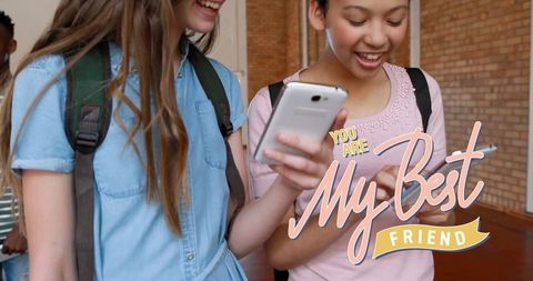 Two Diverse Female Friends Sharing Happiness on Smartphones