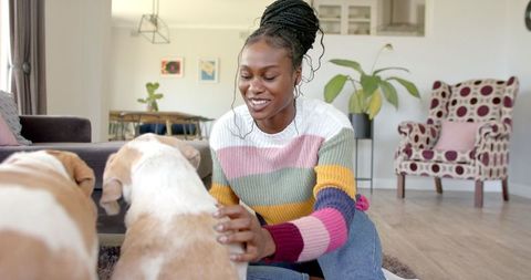 African American Woman in Cozy Living Room Celebrating with Dog