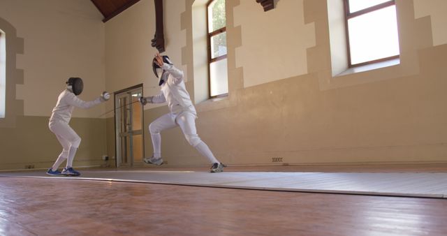 Two Fencers Engaging in a Match in Gymnasium - Download Free Stock Images Pikwizard.com
