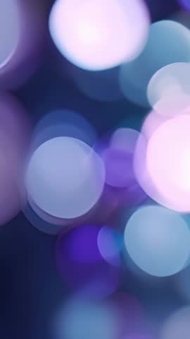 Drifting indigo bokeh circles creating calming ambient loop vertical video