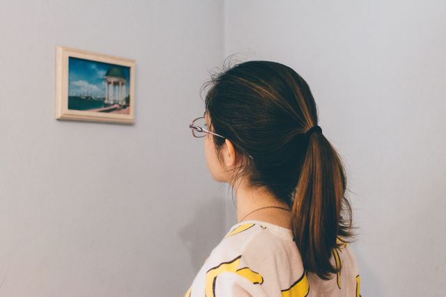 Woman With Ponytail Looking at Art in Minimalistic Room - Download Free Stock Photos Pikwizard.com
