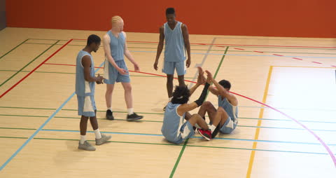 Basketball Team Practicing Support and Teamwork on Court