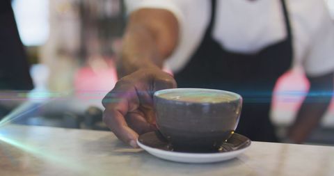 Barista Serving Hot Coffee in Ceramic Cup at Cafe Counter
