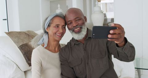 Smiling Couple Taking Selfie in Cozy Living Room - Download Free Stock Images Pikwizard.com