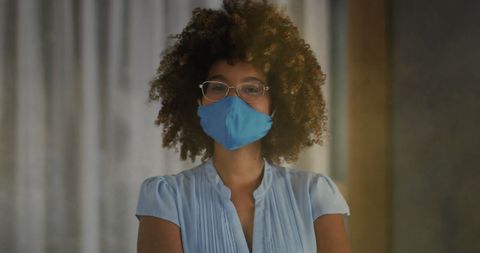 Confident Woman with Curly Hair Wearing Face Mask