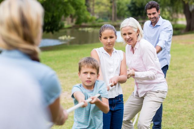 Multi-generation family pulling a rope in tug of war - Download Free Stock Photos Pikwizard.com