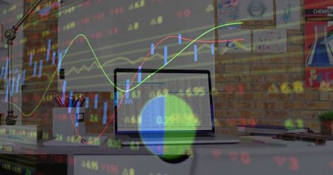 Open Laptop Displaying Vibrant Stock Charts in Urban Workspace