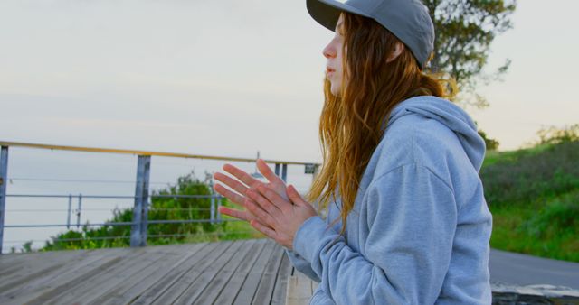 Young Woman Meditating by Ocean Boardwalk in Morning Light - Download Free Stock Images Pikwizard.com