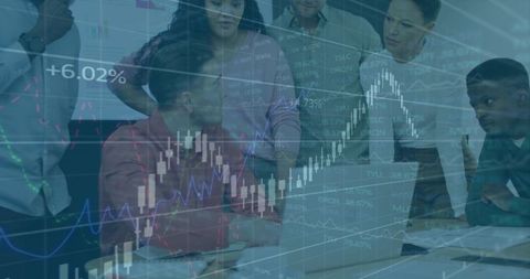 Business team collaborating over laptop with overlaid stock charts and data visualization