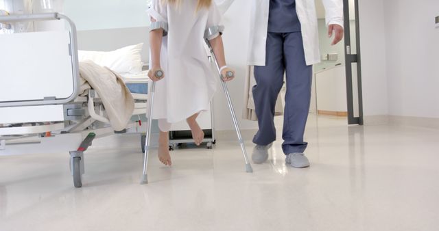 Patient on Crutches Assisted by Doctor in Hospital Room - Download Free Stock Images Pikwizard.com