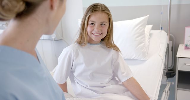 Smiling Young Girl in Hospital Bed Interacting with Nurse - Download Free Stock Images Pikwizard.com