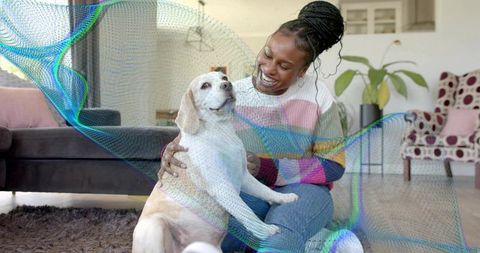 Smiling Woman Enjoying Time With Happy Dog in Cozy Living Room
