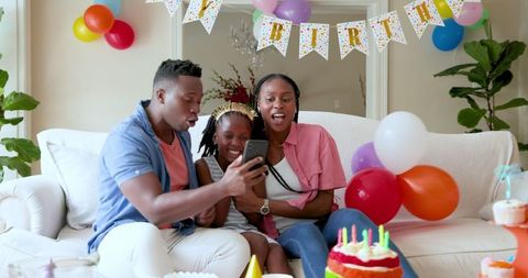 Joyful Family Celebrating Birthday with Decorations and Cake