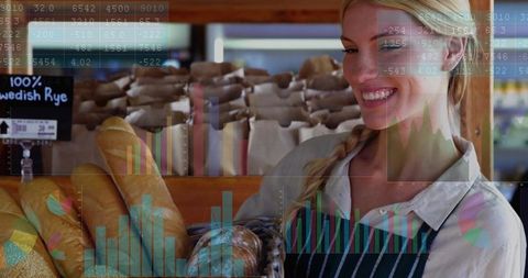 Smiling baker arranging artisan breads in basket behind wooden counter with data overlay