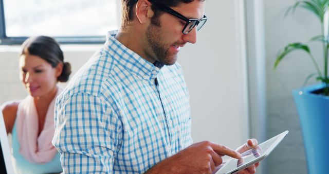 Businessman Using Tablet in Modern Office Environment - Download Free Stock Images Pikwizard.com