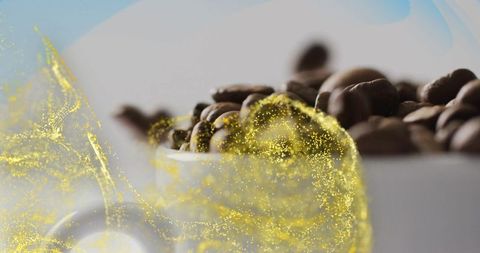 Roasted coffee beans in ceramic cup with golden aura